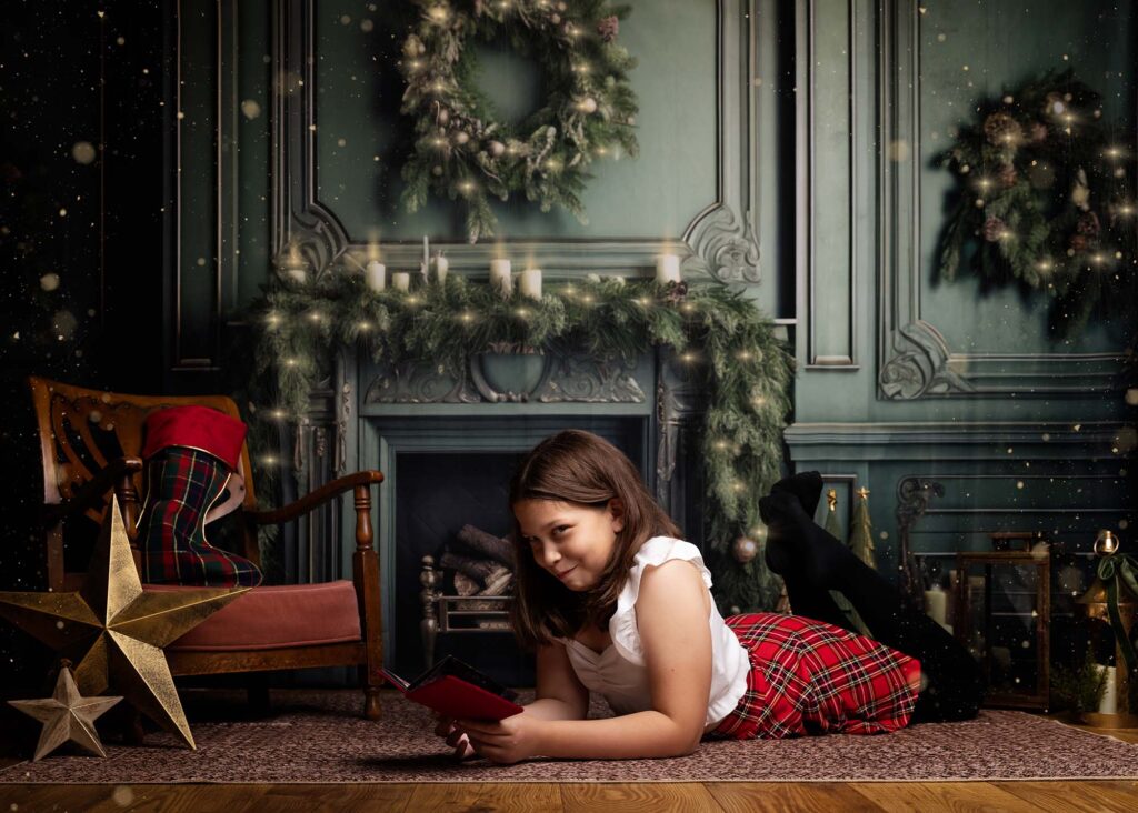 Girl lying on the rug by the festive fireplace, Christmas mini session